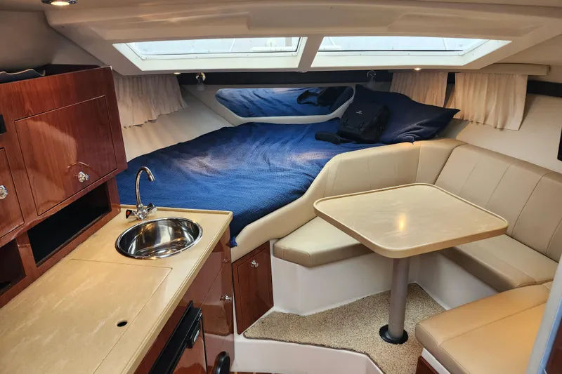 Slide: The Image of 2011 Regal 3060 Express Cruiser interior with kitchenette and seating area. - 24