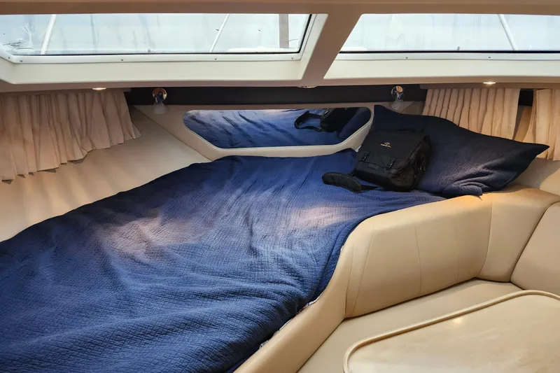 Slide: The Image of 2011 Regal 3060 Express Cruiser interior with bed, skylights, and kitchenette. - 26