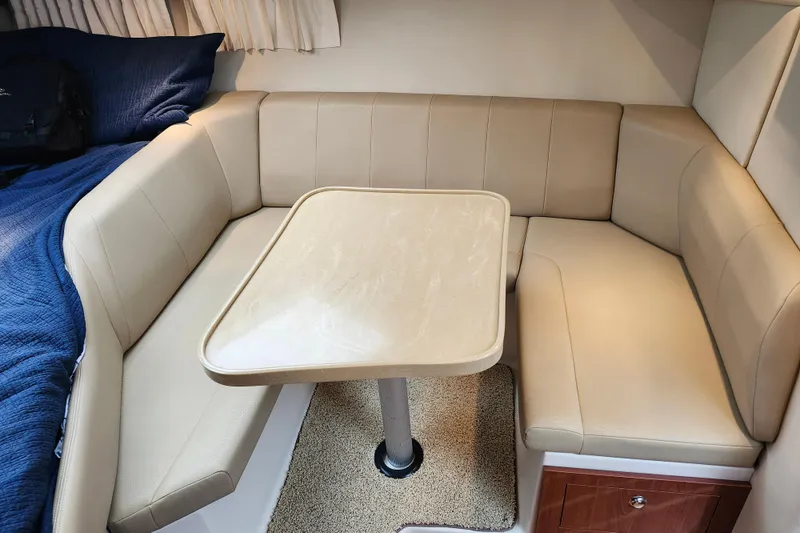 Slide: The Image of Interior cabin of 2011 Regal 3060 Express Cruiser with blue bedding and beige seating. - 27