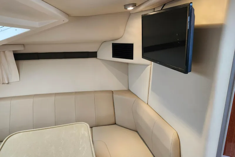 Slide: The Image of Interior of 2011 Regal 3060 Express Cruiser with beige seating and table. - 28