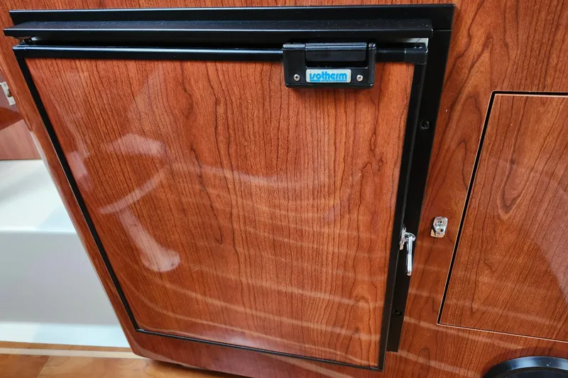 Slide: The Image of Compact kitchen area in a 2011 Regal 3060 Express Cruiser with stove, sink, and storage. - 31