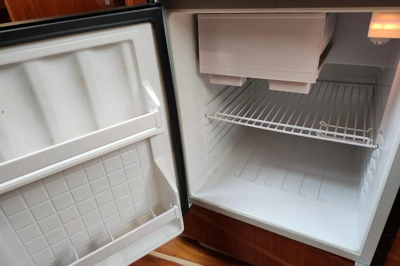 Slide: The Image of Wooden cabinet door on 2011 Regal 3060 Express Cruiser with black trim and latch. - 32