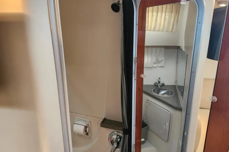 Slide: The Image of 2011 Regal 3060 Express Cruiser bathroom with sink, toilet, and towel. - 38