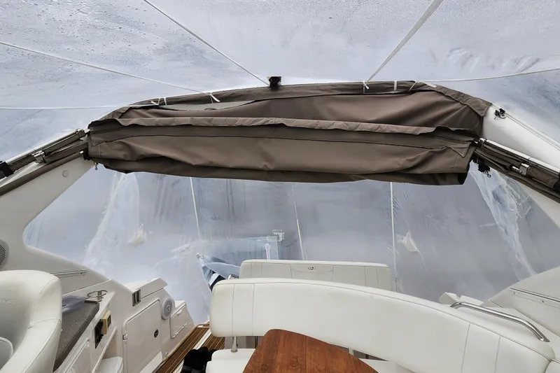 Slide: The Image of 2011 Regal 3060 Express Cruiser interior with wooden table and white seating. - 6