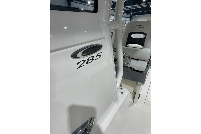 Slide: The Image of 2026 Cobia 285 Open Center Console boat interior with steering wheel and seating. - 17