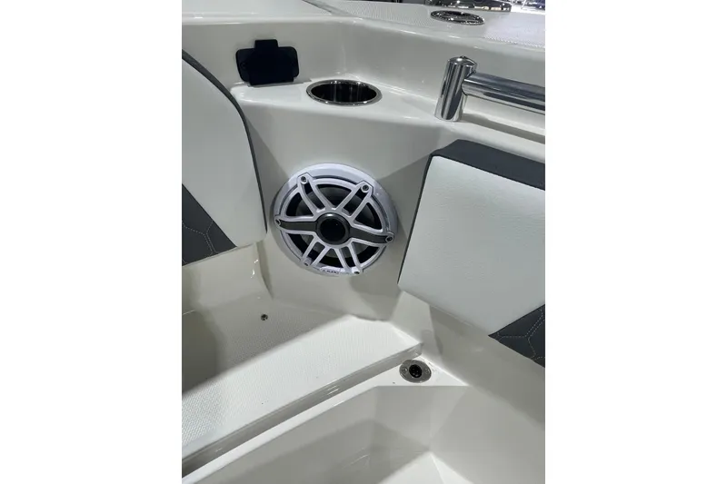 Slide: The Image of 2026 Cobia 285 Open Center Console boat interior with speaker and cup holder. - 19