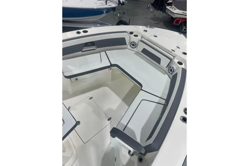 Slide: The Image of 2026 Cobia 285 Open Center Console boat interior with cushioned seating and storage compartments. - 22