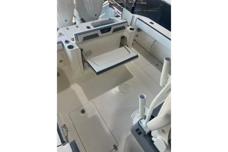 Slide: The Image of 2026 Cobia 285 Open Center Console boat interior with seating and storage features. - 24