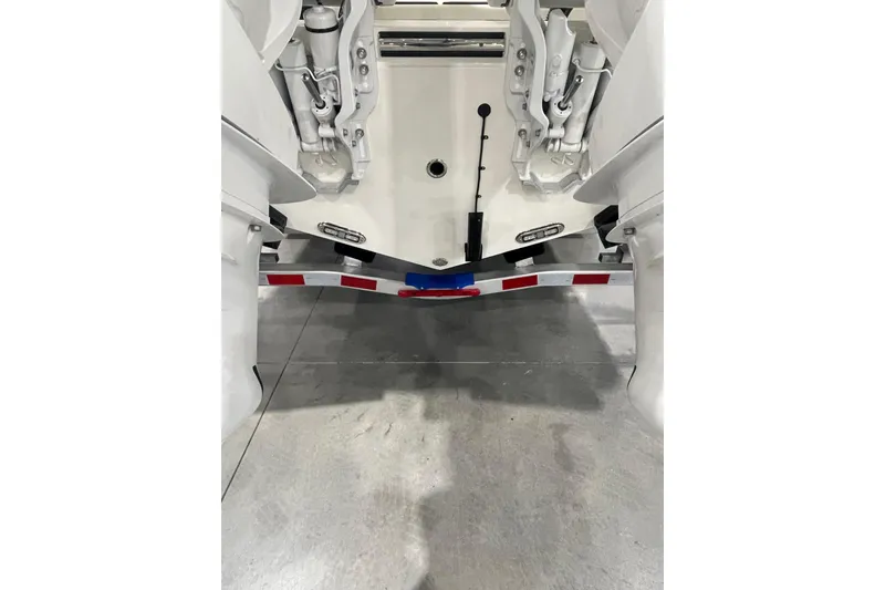 Slide: The Image of 2026 Cobia 285 Open Center Console boat on trailer, rear view. - 3