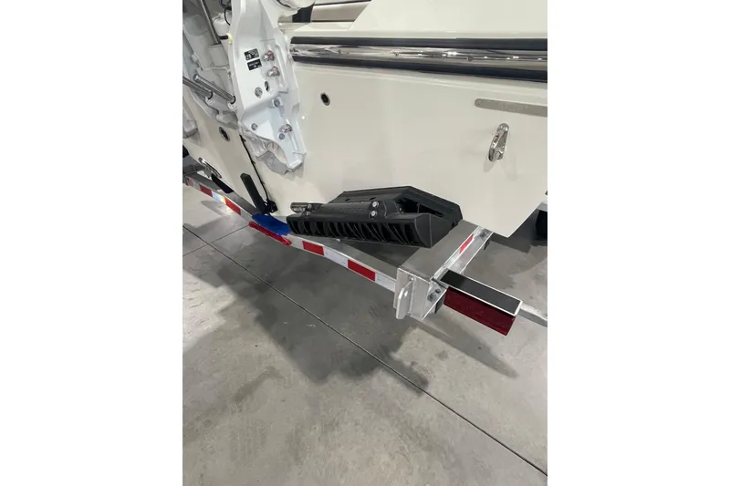 Slide: The Image of 2026 Cobia 285 Open Center Console boat on trailer, rear view in garage. - 5