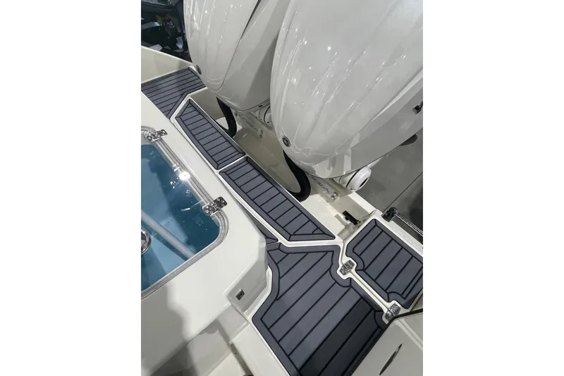 Slide: The Image of 2026 Cobia 285 Open Center Console boat deck with dual engines and sleek design. - 8