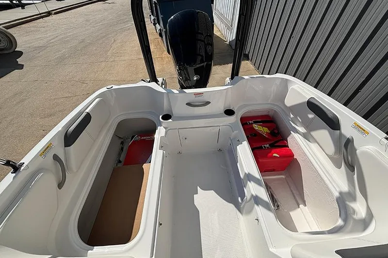 Slide: The Image of 2026 Bayliner Element E18 boat interior with storage compartments and outboard motor. - 14