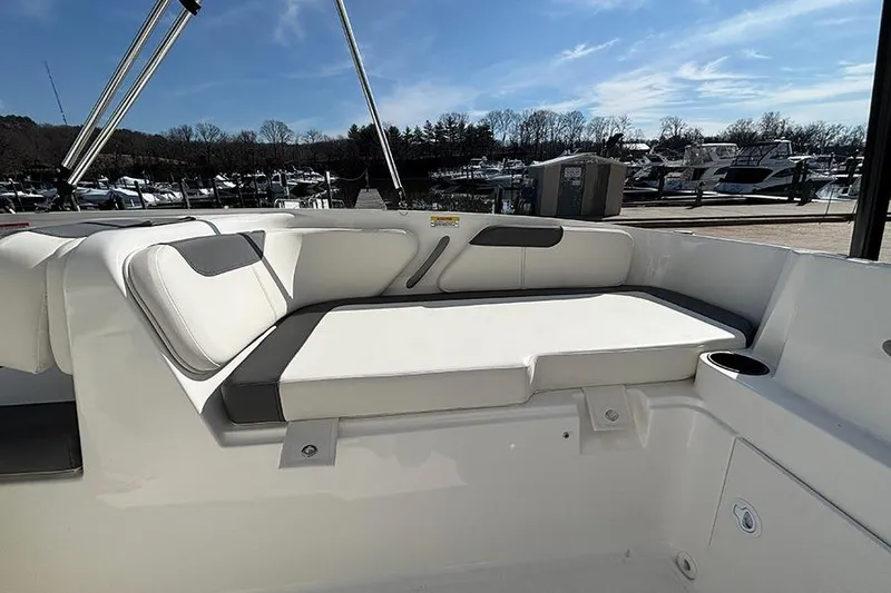 Slide: The Image of 2026 Bayliner Element E18 boat interior with cushioned seating and cup holder. - 15