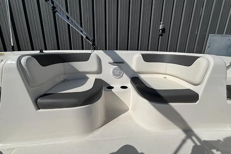 Slide: The Image of 2026 Bayliner Element E18 boat interior with cushioned seating and speaker. - 16