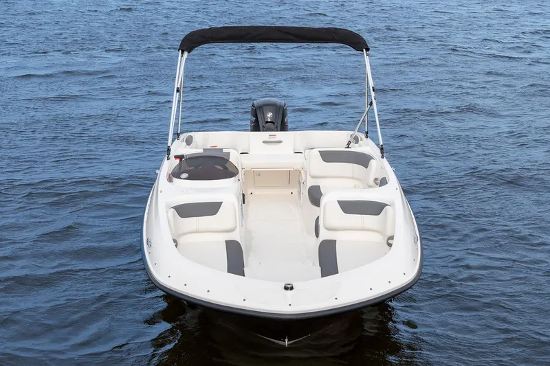 Slide: The Image of 2026 Bayliner Element E18 boat on trailer, parked outside a metal building. - 4