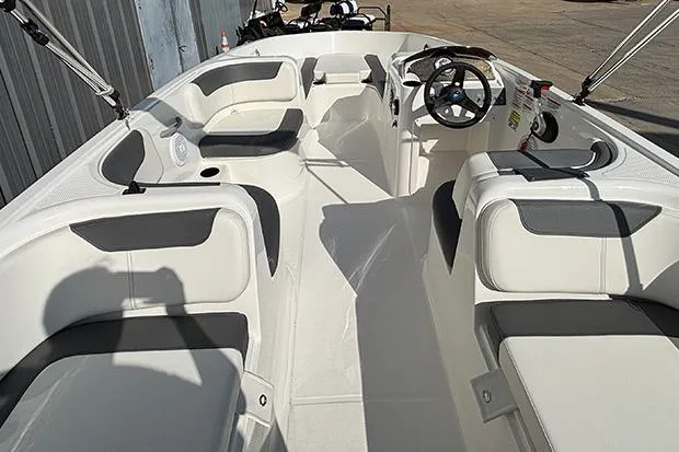 Slide: The Image of 2026 Bayliner Element E18 boat interior with spacious seating and modern steering console. - 8