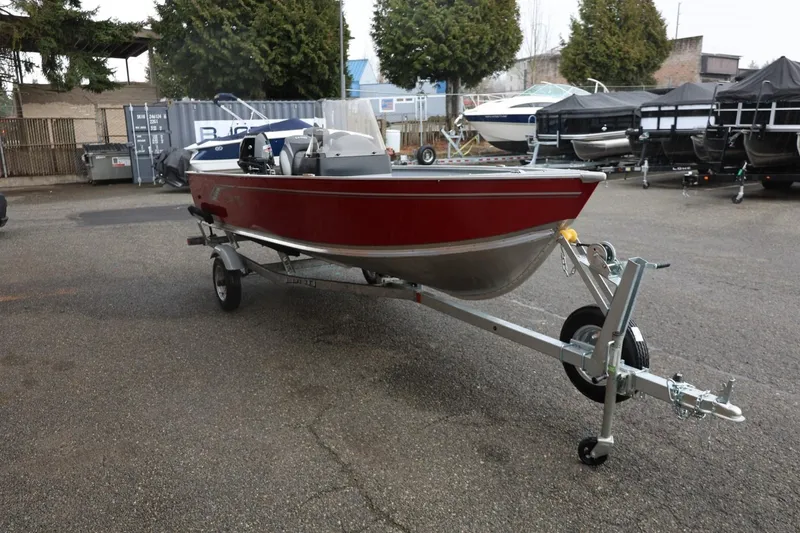 Slide: The Image of 2026 Lund 1600 Fury SS boat on trailer in outdoor lot. - 10