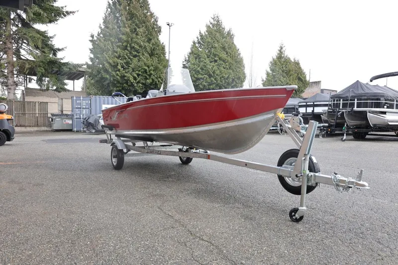 Slide: The Image of 2026 Lund 1600 Fury SS boat on trailer, parked outdoors. - 11