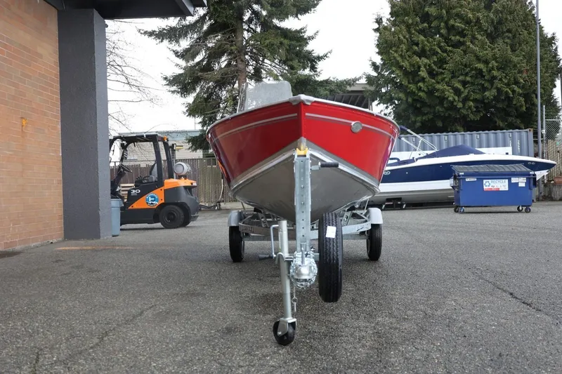 Slide: The Image of 2026 Lund 1600 Fury SS boat on trailer in outdoor setting. - 13