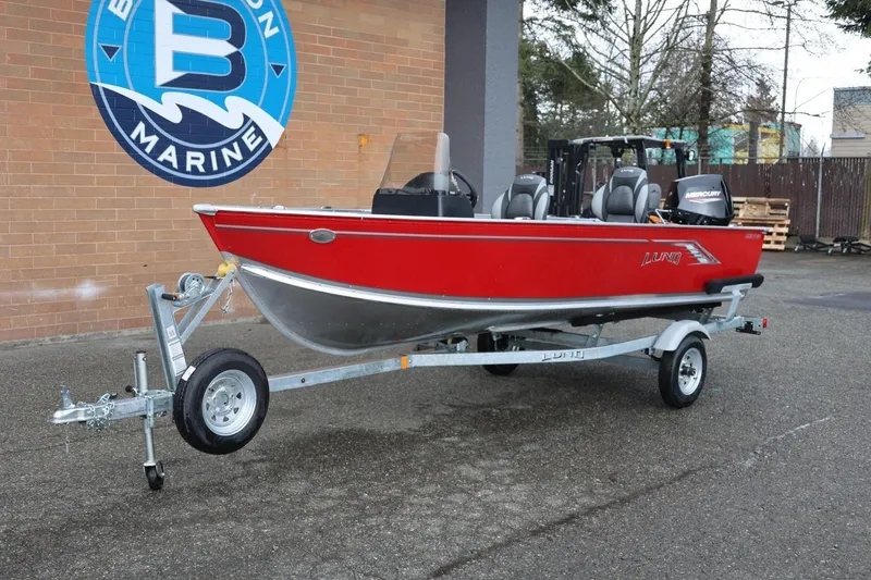 Slide: The Image of 2026 Lund 1600 Fury SS boat in red on trailer at dealership. - 14
