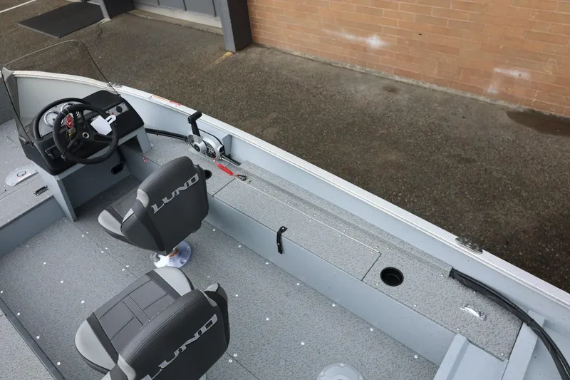 Slide: The Image of 2026 Lund 1600 Fury SS boat interior with steering wheel and seating. - 17