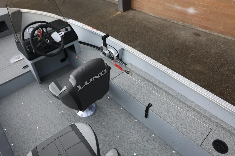 Slide: The Image of 2026 Lund 1600 Fury SS boat interior with steering wheel and seating. - 18