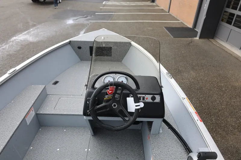 Slide: The Image of 2026 Lund 1600 Fury SS boat interior with steering wheel and dashboard. - 20