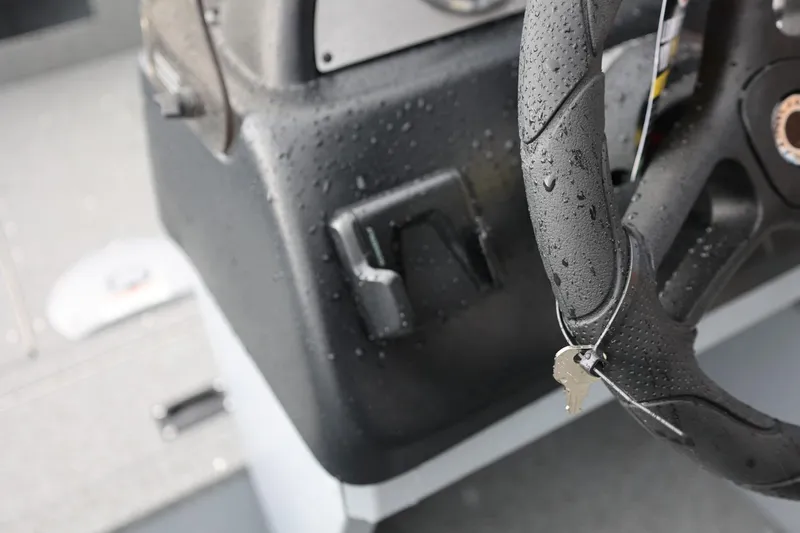 Slide: The Image of Wet steering wheel and keys in a 2026 Lund 1600 Fury SS boat cockpit. - 22