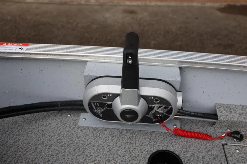 Slide: The Image of Control panel of 2026 Lund 1600 Fury SS boat with throttle and safety features. - 23