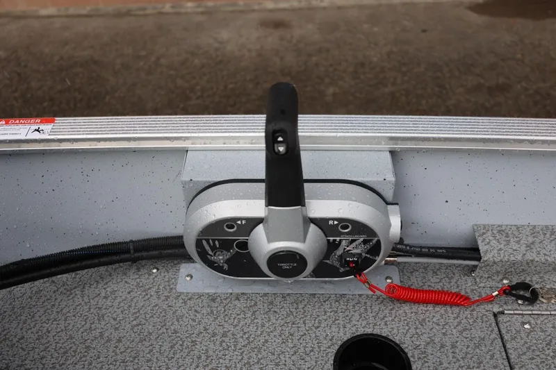 Slide: The Image of Control panel of 2026 Lund 1600 Fury SS boat with throttle and safety lanyard. - 24