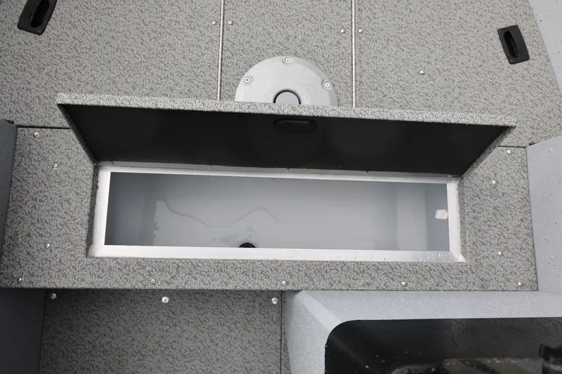 Slide: The Image of 2026 Lund 1600 Fury SS boat storage compartment with open lid, showcasing interior space. - 26