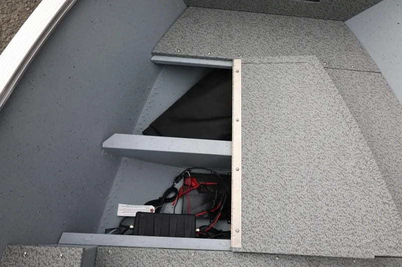 Slide: The Image of 2026 Lund 1600 Fury SS boat interior with storage compartment and wiring. - 27