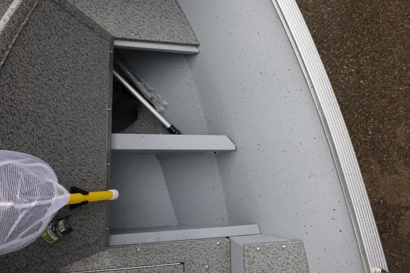 Slide: The Image of Storage compartment of 2026 Lund 1600 Fury SS boat with fishing net and equipment. - 28