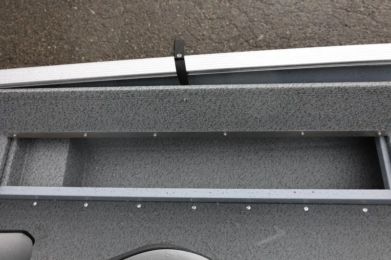 Slide: The Image of 2026 Lund 1600 Fury SS boat interior with textured gray flooring. - 32