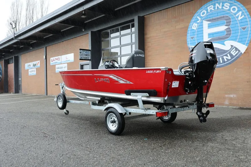 Slide: The Image of 2026 Lund 1600 Fury SS boat on trailer outside Bjornson Marine dealership. - 4