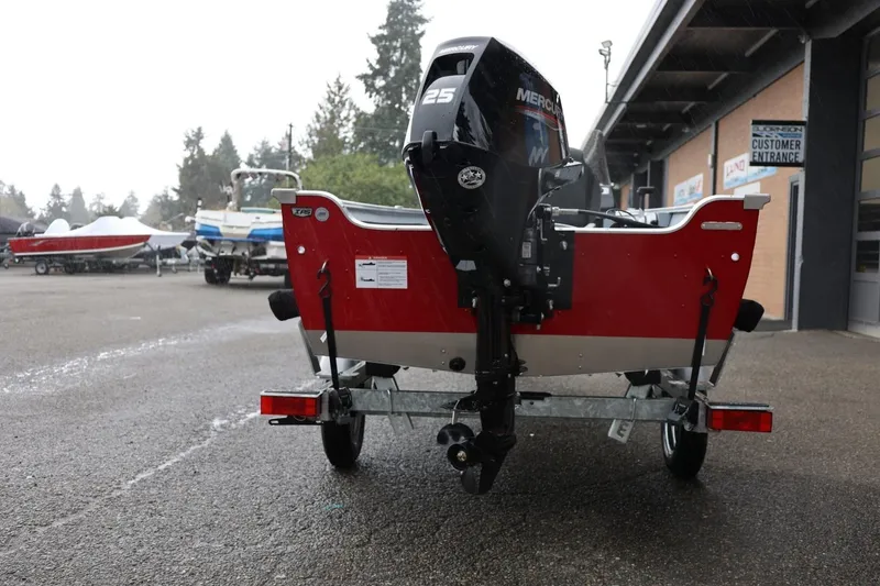 Slide: The Image of 2026 Lund 1600 Fury SS boat with Mercury engine on trailer, parked outdoors. - 6