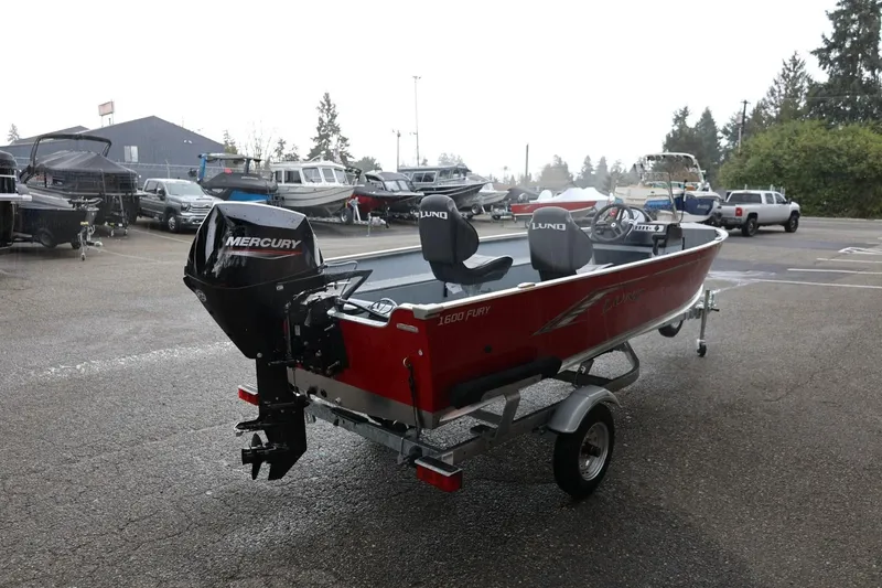 Slide: The Image of 2026 Lund 1600 Fury SS boat with Mercury engine on trailer in parking lot. - 8