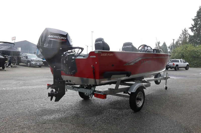 Slide: The Image of 2026 Lund 1600 Fury SS boat with Mercury engine on trailer in parking lot. - 9
