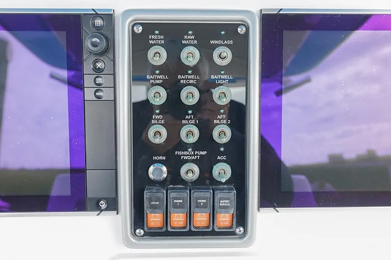 Slide: The Image of Control panel of a 2015 Everglades 295 Center Console boat with various switches. - 15