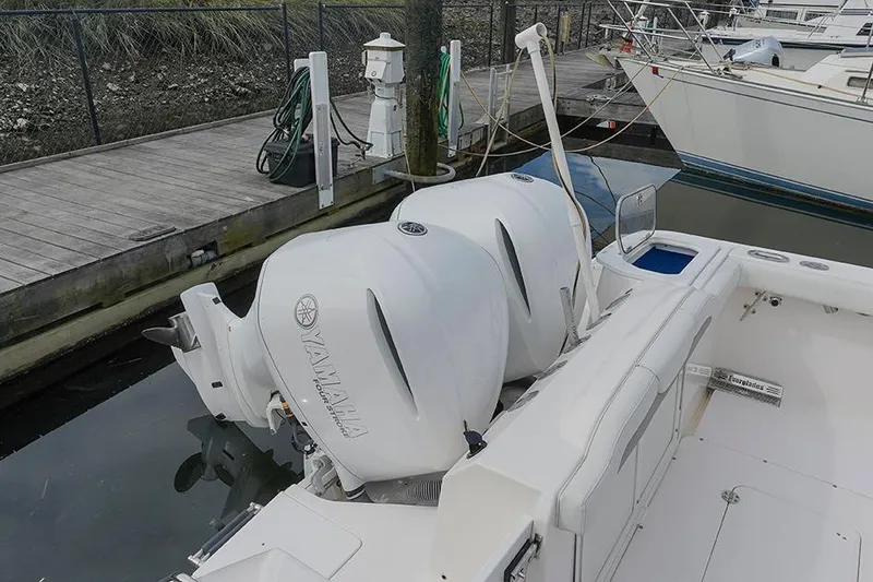 Slide: The Image of 2015 Everglades 295 Center Console with twin Yamaha outboard engines docked at marina. - 22