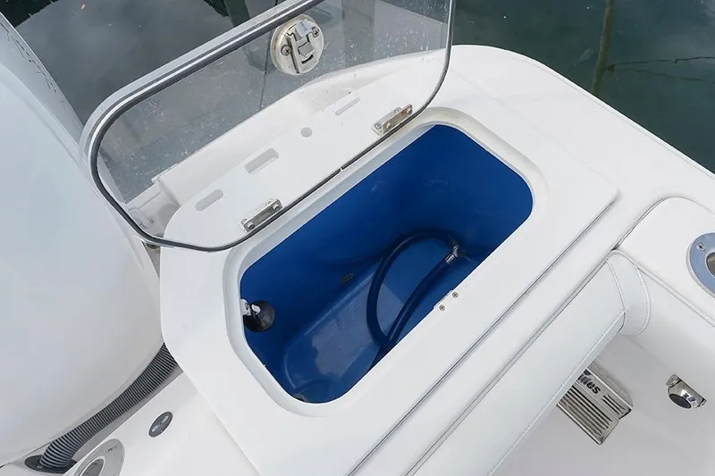 Slide: The Image of Open storage compartment on 2015 Everglades 295 Center Console boat. - 27