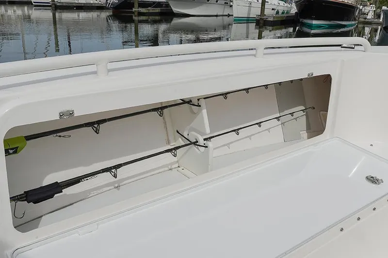 Slide: The Image of 2015 Everglades 295 Center Console fishing rod storage compartment on a docked boat. - 29