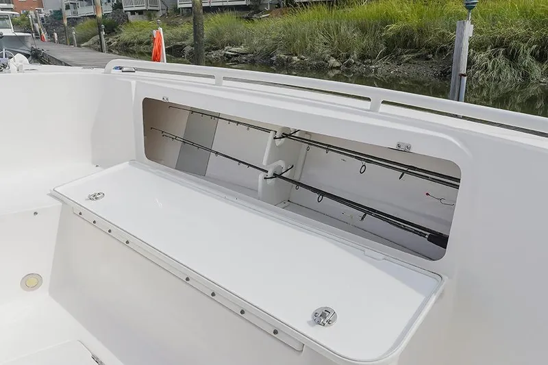 Slide: The Image of 2015 Everglades 295 Center Console boat with open rod storage compartment. - 30