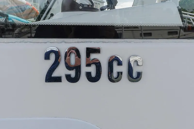 Slide: The Image of Everglades 295 Center Console 2015 boat model emblem on white surface. - 33