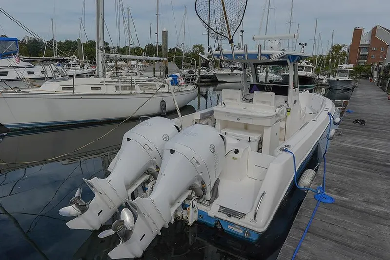 Slide: The Image of 2015 Everglades 295 Center Console boat docked with twin outboard engines. - 4