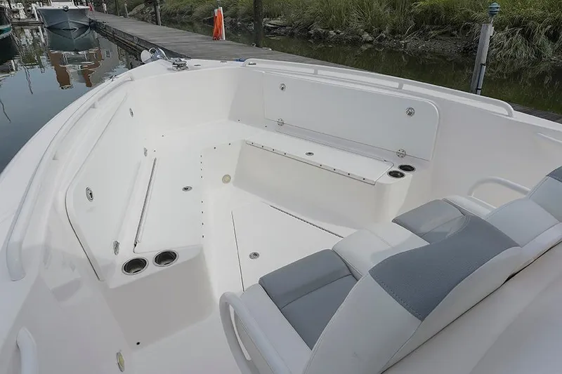Slide: The Image of 2015 Everglades 295 Center Console boat interior with seating and cup holders. - 7