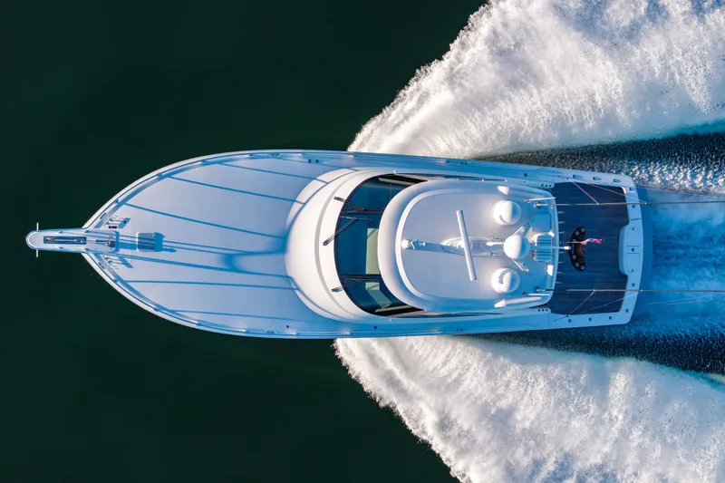 Slide: The Image of Aerial view of 2022 Viking 54 Sport Coupe yacht cruising on water. - 16