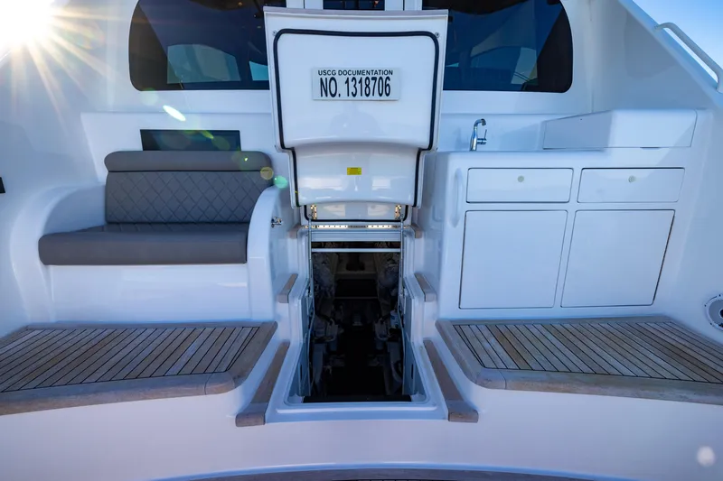 Slide: The Image of 2022 Viking 54 Sport Coupe yacht interior with seating, storage, and engine access. - 23