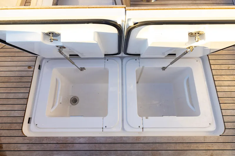 Slide: The Image of Open storage compartments on 2022 Viking 54 Sport Coupe yacht deck. - 29