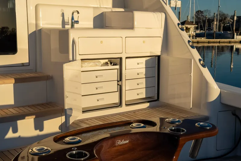 Slide: The Image of 2022 Viking 54 Sport Coupe yacht interior with storage cabinets and sink. - 32